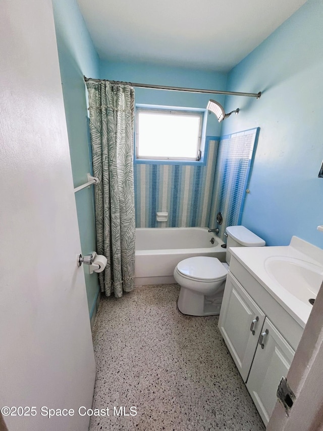 bathroom featuring speckled floor, toilet, shower / bathtub combination with curtain, and vanity