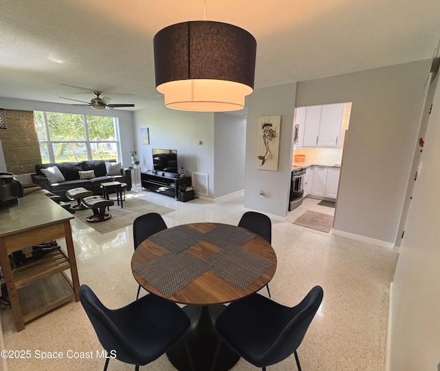 dining room with ceiling fan and a textured ceiling