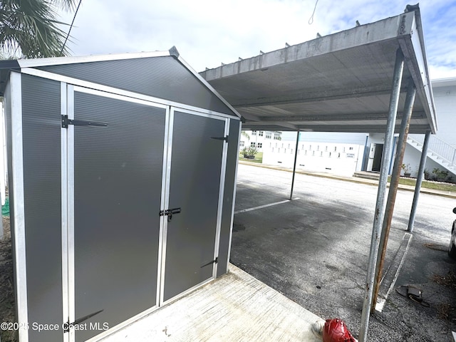 view of outbuilding with a carport