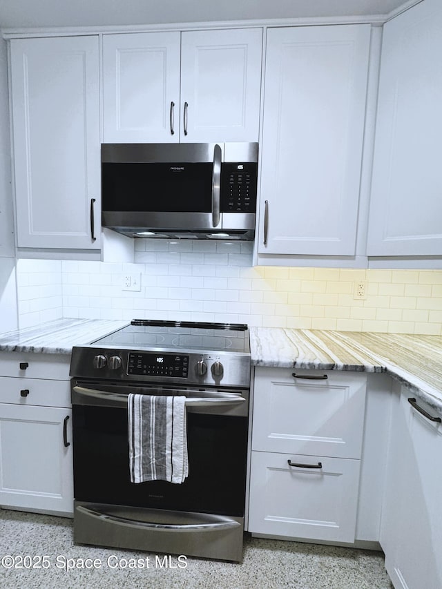 kitchen with appliances with stainless steel finishes and white cabinets