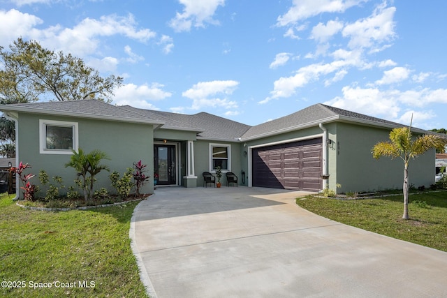 view of front facade with a garage and a front lawn