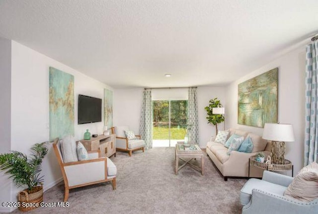 living room with light carpet and a textured ceiling