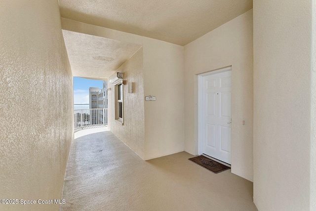 hallway featuring a textured ceiling