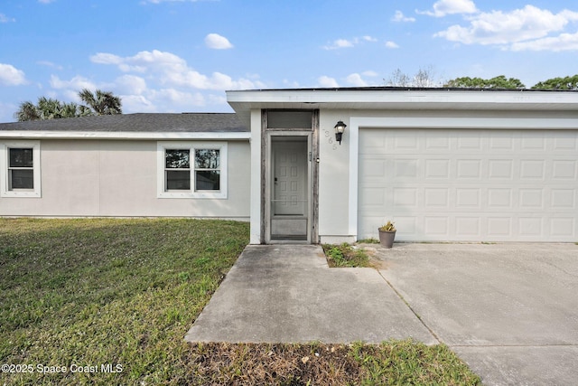 view of front of home with a garage and a front lawn