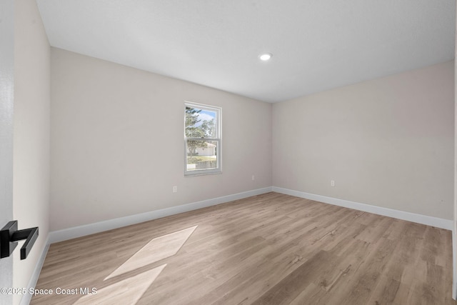 spare room with light hardwood / wood-style floors