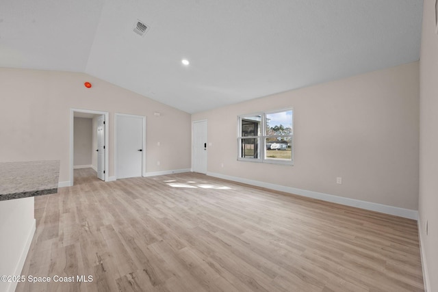 unfurnished living room with vaulted ceiling and light hardwood / wood-style floors