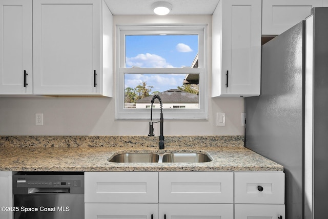 kitchen with sink, white cabinets, and black dishwasher