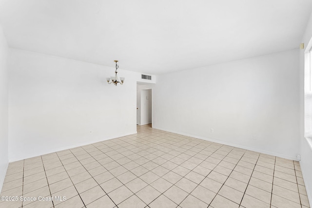 empty room featuring visible vents and a notable chandelier