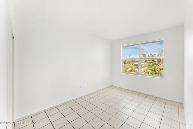 spare room featuring baseboards