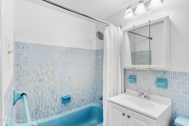 bathroom featuring shower / bath combination with curtain, tile walls, and vanity