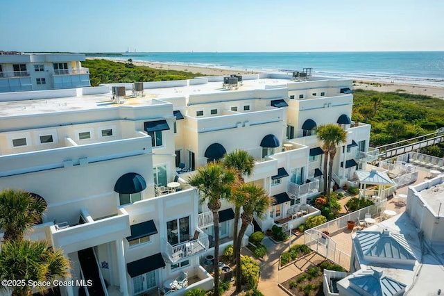 birds eye view of property with a water view and a beach view