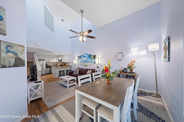 8600 Ridgewood Ave Unit 1308, Cape Canaveral, FL 32920 - dining space featuring ceiling fan, light wood finished floors, and a towering ceiling