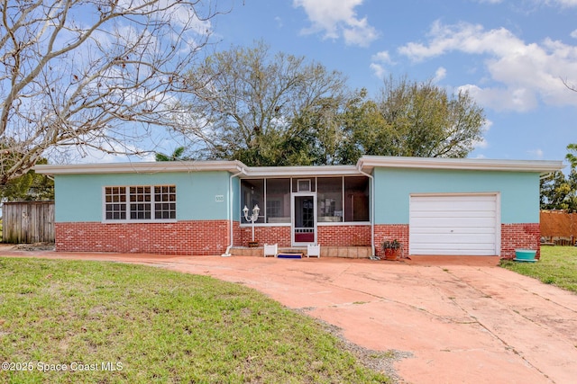 ranch-style home featuring a front yard, brick siding, driveway, and an attached garage