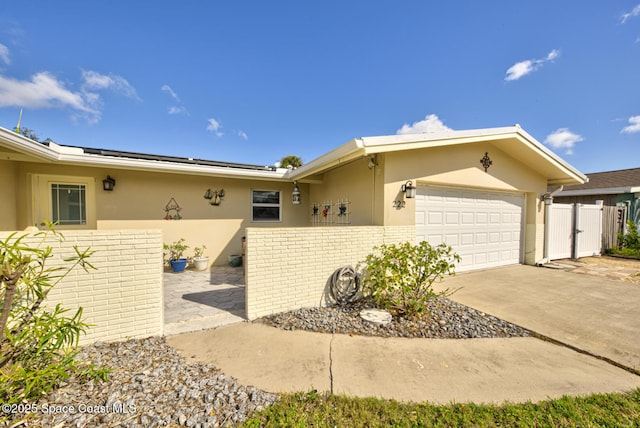 view of front of property with a garage and solar panels