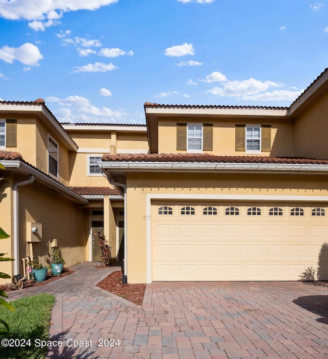 mediterranean / spanish-style house with a garage