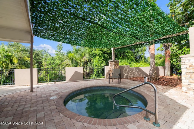 view of pool featuring an in ground hot tub and a patio