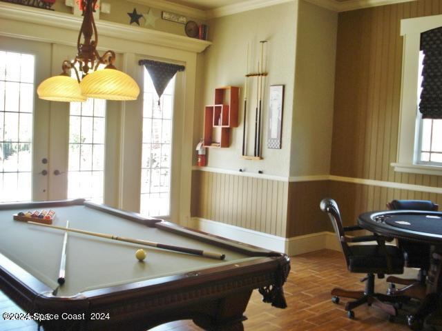 rec room with a healthy amount of sunlight, ornamental molding, pool table, and hardwood / wood-style floors