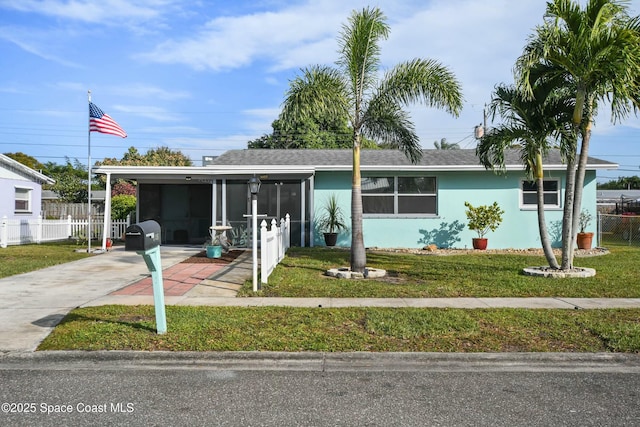 view of front facade with a carport and a front yard