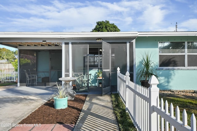 rear view of property with a sunroom