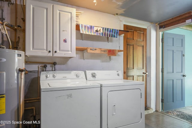 washroom with independent washer and dryer, cabinets, electric water heater, and light tile patterned floors