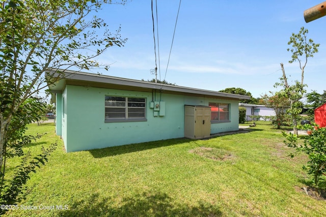 rear view of property with a lawn