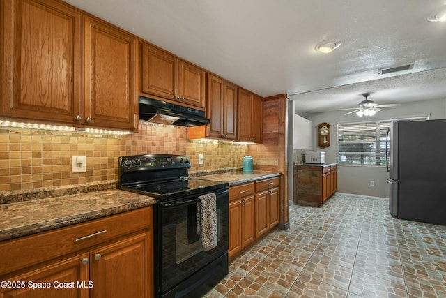 kitchen featuring stainless steel refrigerator, tasteful backsplash, dark stone countertops, ceiling fan, and black electric range