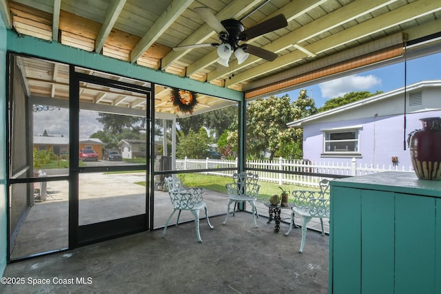 unfurnished sunroom featuring plenty of natural light and ceiling fan