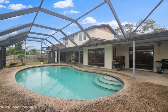 view of swimming pool with a patio area and glass enclosure