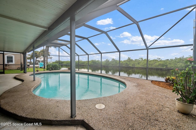 view of swimming pool featuring a lanai, a patio area, and a water view