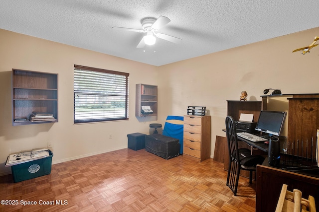 home office featuring ceiling fan, a textured ceiling, and light parquet flooring