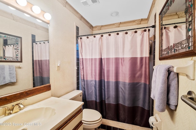 bathroom featuring vanity, crown molding, toilet, and walk in shower