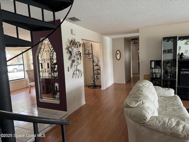 living room with hardwood / wood-style floors and a textured ceiling