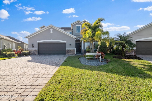 view of front of home with a garage and a front lawn