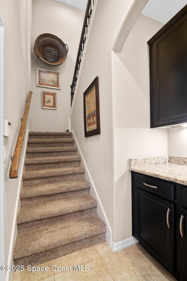 stairs with tile patterned flooring and baseboards