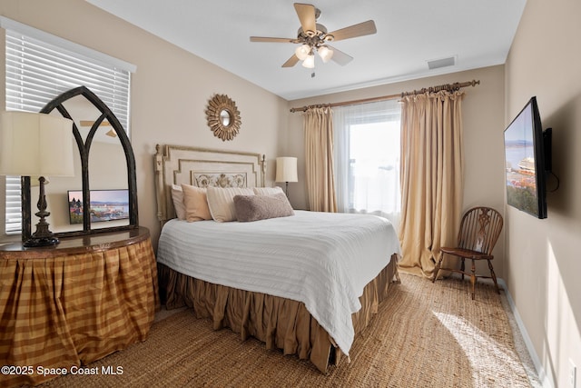 bedroom with a ceiling fan, visible vents, and baseboards