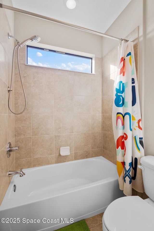 bathroom featuring toilet and shower / bath combo with shower curtain