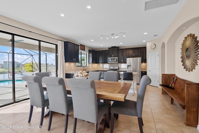 dining room with recessed lighting, a sunroom, visible vents, and light tile patterned floors