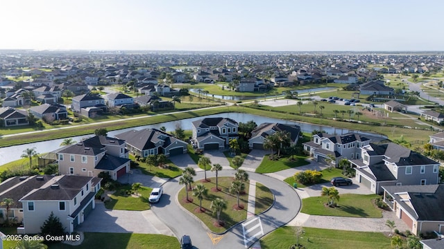 birds eye view of property with a water view and a residential view