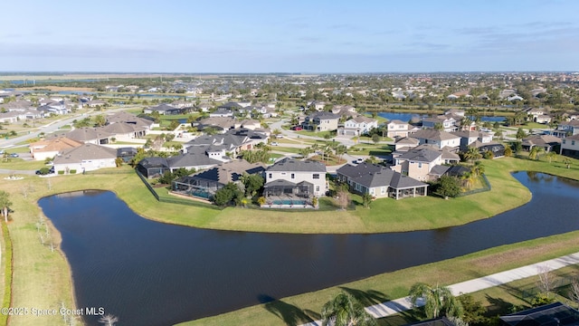 birds eye view of property with a water view and a residential view