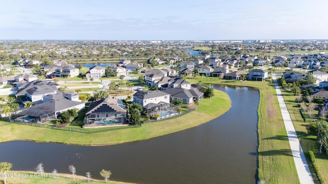drone / aerial view with a water view and a residential view