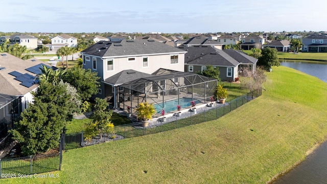 birds eye view of property with a water view and a residential view