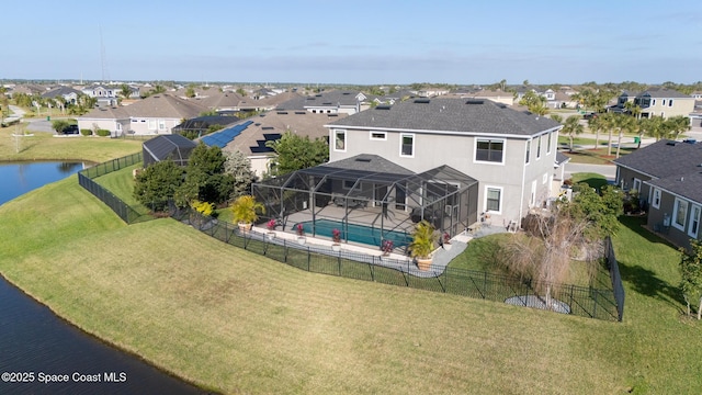 drone / aerial view featuring a water view and a residential view