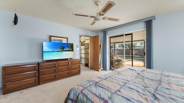 bedroom featuring light carpet, ceiling fan, a textured ceiling, and access to exterior