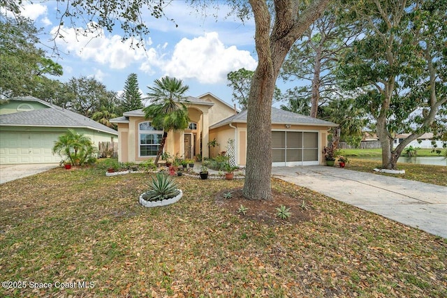 view of front of property featuring a garage, concrete driveway, a front yard, and stucco siding