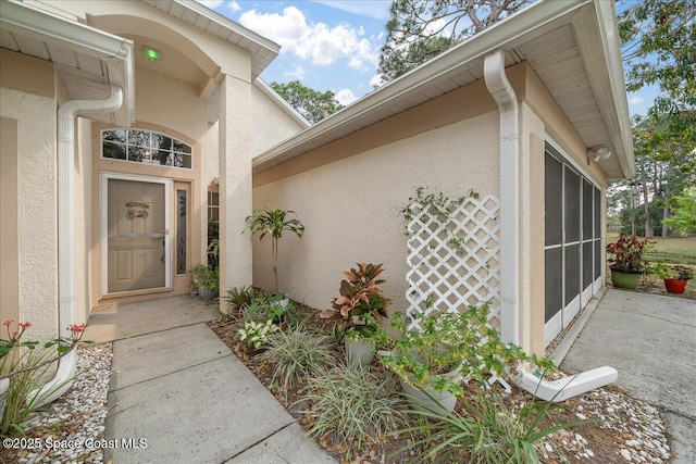 property entrance with stucco siding