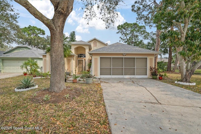 view of front of home featuring concrete driveway, an attached garage, and stucco siding