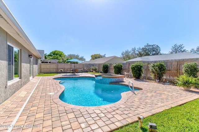 view of swimming pool with an in ground hot tub and a patio area