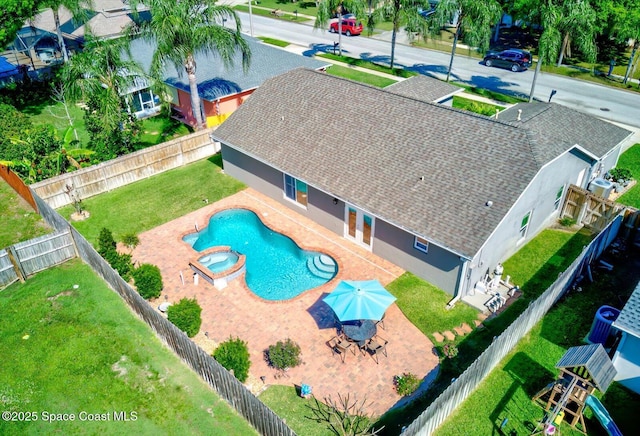 view of swimming pool featuring an in ground hot tub, a patio, a playground, and a yard