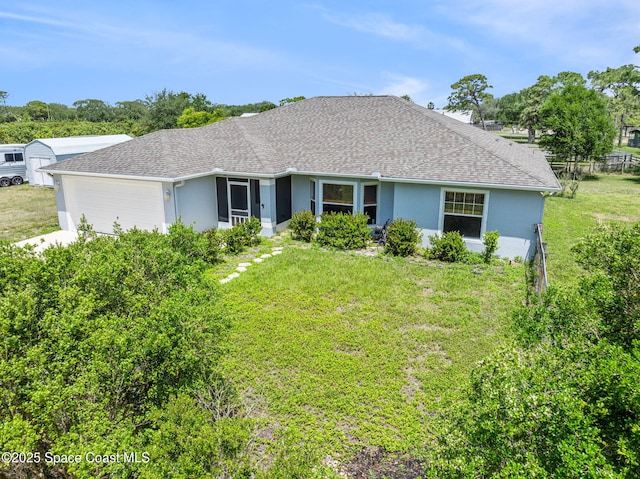 ranch-style home with an attached garage, a front yard, stucco siding, and fence