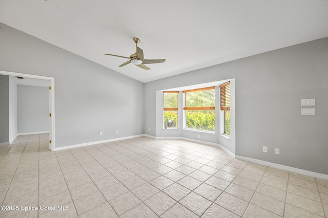 unfurnished room featuring light tile patterned floors, vaulted ceiling, baseboards, and ceiling fan